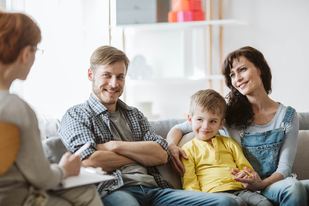 Parents and their child undergoing therapy with a psychologist