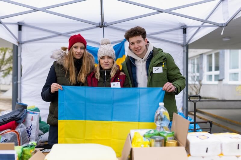 équipe de bénévoles distribuant de la nourriture, des boissons et d'autres dons aux réfugiés à la frontière ukrainienne.