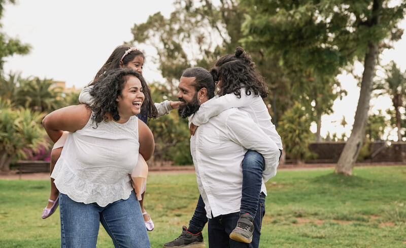 happy parents and children having fun together outdoors