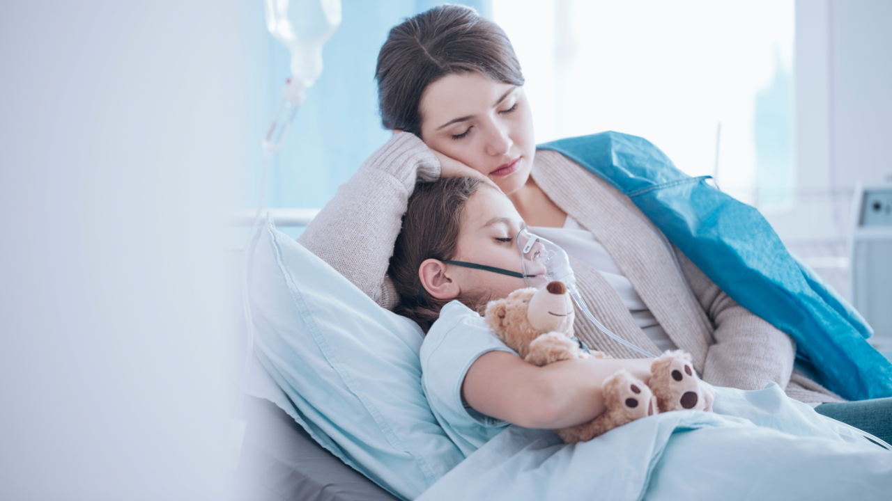 mother comforting her little girl at the hospital